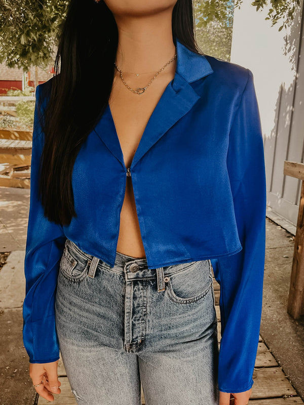 Model wearing royal blue silk crop top, showing off the front details.