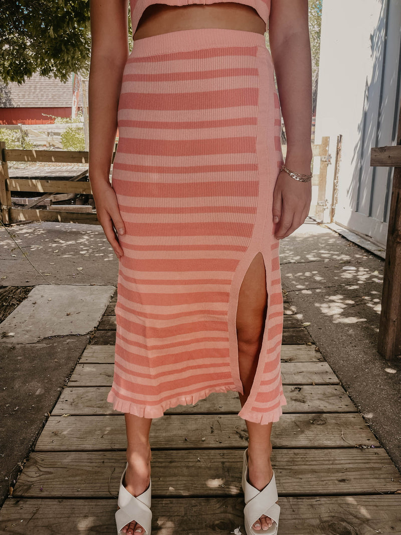 Model wearing pink striped skirt.